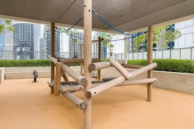 a wooden swing in a building with buildings in the background at Frank Porter - Reva Residences in Dubai