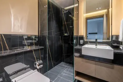 a bathroom with a toilet and a sink and a mirror at GuestReady - Mesmerizing views of the Burj Khalifa in Dubai