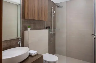 a bathroom with a shower and a sink and a toilet at Staybridge Suites Dubai Business Bay by IHG in Dubai