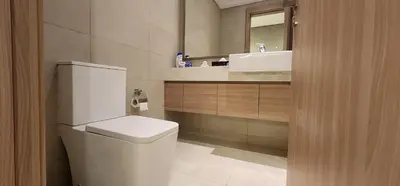 a bathroom with a white toilet and a sink at Luxury Studio, 15m to Dubai Mall! in Dubai