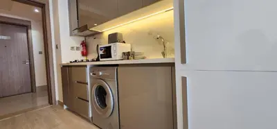 a kitchen with a washing machine and a sink at Luxury Studio, 15m to Dubai Mall! in Dubai