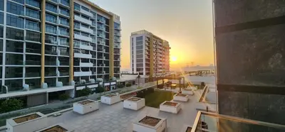 a view of a balcony of a building with a sunset at Luxury Studio, 15m to Dubai Mall! in Dubai