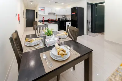 a table with a plate of bananas on it in a kitchen at Contemporary furnishing I City skyline view in Dubai