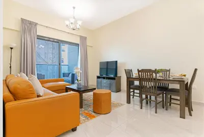 a living room with a couch and a dining room at Contemporary furnishing I City skyline view in Dubai