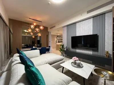 a living room with two white couches and a tv at Dreamy Getaway 4B in Burj Royale Downtown in Dubai