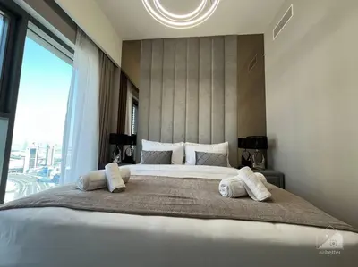 a bedroom with a large bed with a large window at Dreamy Getaway 4B in Burj Royale Downtown in Dubai