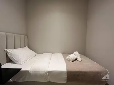 a white bed with two pillows on top of it at Dreamy Getaway 4B in Burj Royale Downtown in Dubai