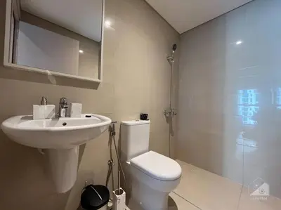 a bathroom with a toilet and a sink and a shower at Dreamy Getaway 4B in Burj Royale Downtown in Dubai