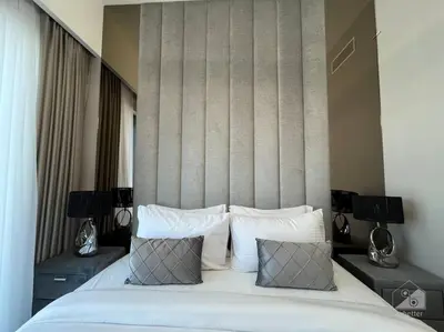 a bedroom with a large white bed with pillows at Dreamy Getaway 4B in Burj Royale Downtown in Dubai