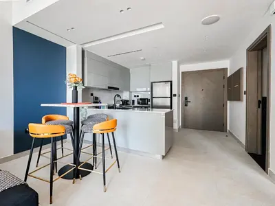a kitchen with a table and chairs in a room at Trophy - Luxury Canal View Suites. in Dubai