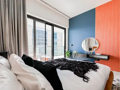 a bedroom with a large bed and a mirror at Trophy - Luxury Canal View Suites. in Dubai