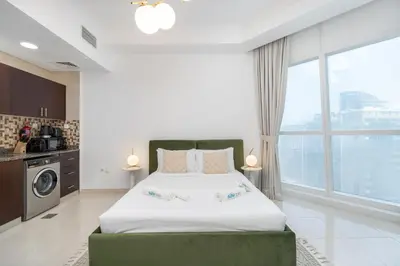 a bedroom with a bed and a large window at Comfortable Broad Studio in Business Bay-Suiteable in Dubai
