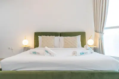 a large white bed with two pillows on it at Comfortable Broad Studio in Business Bay-Suiteable in Dubai