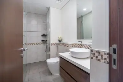 a bathroom with a sink and a toilet and a shower at Business Bay Bliss 1 bedroom apartment - Suiteable in Dubai