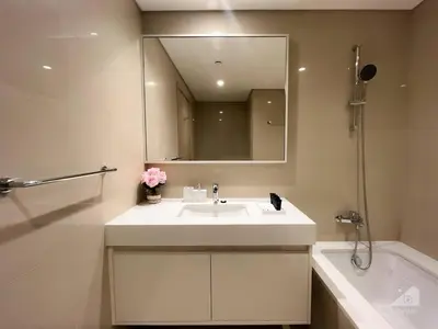 a bathroom with a sink and a mirror and a tub at NEW! Modern Elegance 2B in Burj Royale Downtown in Dubai
