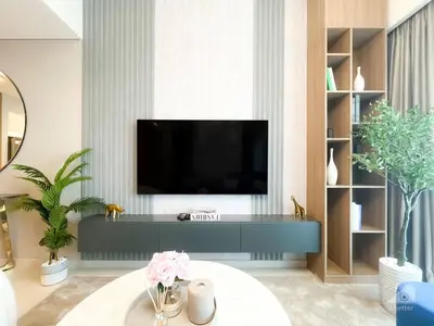 a living room with a flat screen tv on a wall at NEW! Modern Elegance 2B in Burj Royale Downtown in Dubai