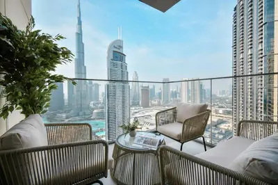 a balcony with chairs and a view of a city at Burj Roayle-Magical Burj & Fountain Sky Views 3+1 BR APT in Dubai
