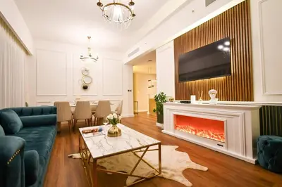 a living room with a couch and a fireplace at Burj Roayle-Magical Burj & Fountain Sky Views 3+1 BR APT in Dubai