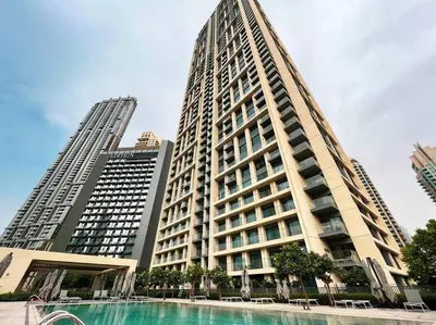 a large building with a pool in front of it at Burj Roayle-Magical Burj & Fountain Sky Views 3+1 BR APT in Dubai