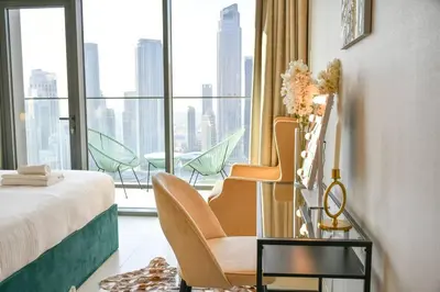 a hotel room with a bed and a window with a view at Burj Roayle-Magical Burj & Fountain Sky Views 3+1 BR APT in Dubai