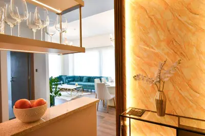 a kitchen and living room with a bowl of fruit on a counter at Burj Roayle-Magical Burj & Fountain Sky Views 3+1 BR APT in Dubai