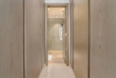a hallway of a bathroom with a walk in shower at One Bedroom - 10min from Burj Khalifa - Lagoon View in Dubai