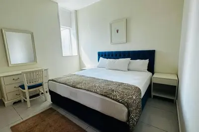 a bedroom with a bed and a chair in it at The Sand Castle- Pinnacle tower, Dubai Marina, Near metro in Dubai