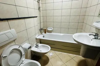 a bathroom with a toilet and a sink and a tub at The Sand Castle- Pinnacle tower, Dubai Marina, Near metro in Dubai