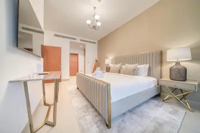 a bedroom with a large bed and a desk at Central Park Towers, City View - DIFC - Mint Stay in Dubai