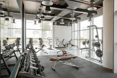 a gym with a lot of treadmills and machines at Central Park Towers, City View - DIFC - Mint Stay in Dubai