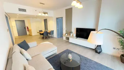 a living room with a couch and a tv at Jumeriah Lake Tower (JLT)-(LAKE VIEW) in Dubai