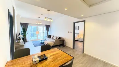 a living room with a dining table and a living room at Jumeriah Lake Tower (JLT)-(LAKE VIEW) in Dubai