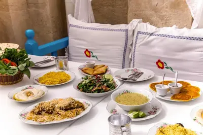 a table with plates of food on a table at Life Above Clouds in Dubai