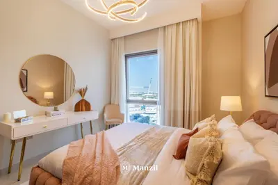 a bedroom with a bed and a desk and a window at Manzil - Sleek 1BR Home in Dubai Creek with Beach & Marina Access in Dubai