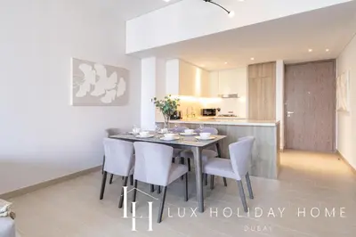 a kitchen and dining room with a table and chairs at LUX LIV Contemporary Full Marina View Suite in Dubai