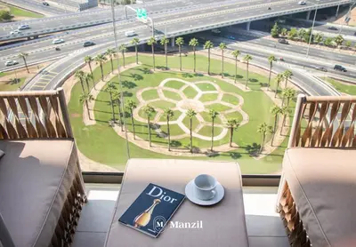 a table with a cup of coffee on top of a window at Azizi Farhad in Dubai