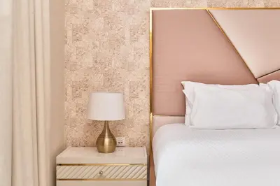 a bedroom with a bed and a lamp on a night stand at BellaVista - Graceful - 1 BR - 29 Boulevard - with Burj Khalifa View in Dubai