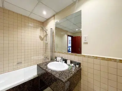 a bathroom with a sink and a mirror at Spacious 4BR Apartment in JBR next to the Beach in Dubai