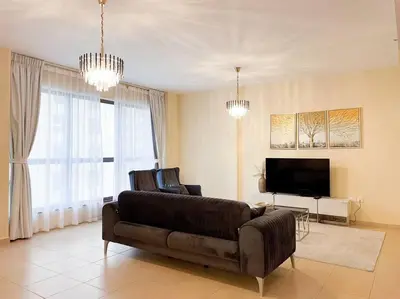 a living room with a couch and a television at Spacious 4BR Apartment in JBR next to the Beach in Dubai