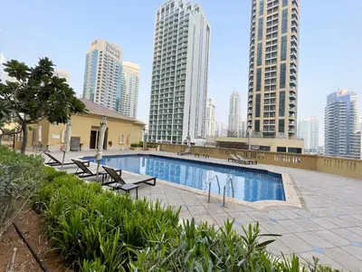 a swimming pool in a city with tall buildings at Spacious 4BR Apartment in JBR next to the Beach in Dubai