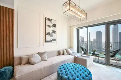 a living room with a couch and a large window at Burj Royale-Enchanting Burj&Fountain full view Sky APT 3+1BR in Dubai