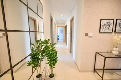 a hallway with a table and a plant at Burj Royale-Enchanting Burj&Fountain full view Sky APT 3+1BR in Dubai