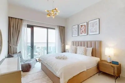 a bedroom with a large bed and a large window at Vacationer I Elegant 2 Bed with City Views I Walk to Dubai Mall & Burj Khalifa I Downtown I Burj Royale Tower in Dubai