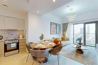 a kitchen and living room with a table and chairs at Vacationer I Elegant 2 Bed with City Views I Walk to Dubai Mall & Burj Khalifa I Downtown I Burj Royale Tower in Dubai
