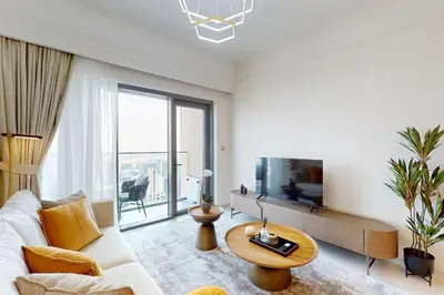 a living room with a couch and a tv at Vacationer I Elegant 2 Bed with City Views I Walk to Dubai Mall & Burj Khalifa I Downtown I Burj Royale Tower in Dubai