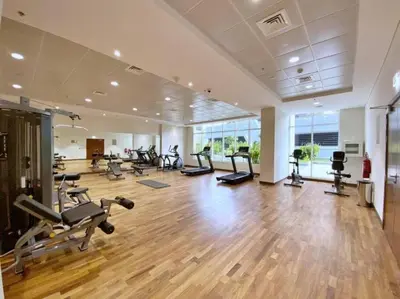a gym with a lot of treadmills and machines at Vacationer l Premium One Bed I Walk to Dubai Mall, Burj Khalifa I Dunya Tower Downtown in Dubai