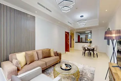 a living room with a couch and a table at Vacationer l Premium One Bed I Walk to Dubai Mall, Burj Khalifa I Dunya Tower Downtown in Dubai