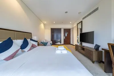 a large bedroom with a large bed and a flat screen tv at Luxury Address Res Dubai Marina Studio in Dubai