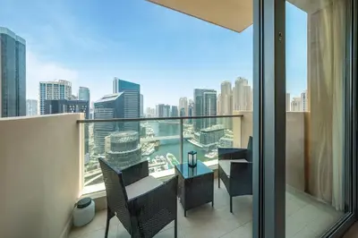 a balcony with chairs and a view of the city at Luxury Address Res Dubai Marina Studio in Dubai