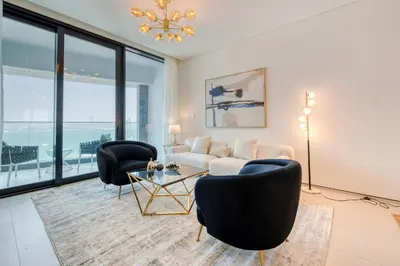 a living room with a couch and chairs and a table at Address JBR with Sea View & Maid Room - Mint Stay in Dubai